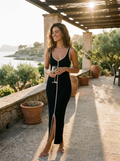 Woman wearing a black ribbed knit slit-front maxi dress