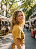 Woman wearing a yellow tie-back wrap cropped short-sleeve blouse