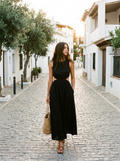 Woman wearing a black cotton cutout sleeveless maxi dress