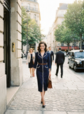 Woman wearing a contrast-trim belted pencil midi dress
