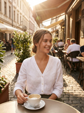 Woman wearing a white V-neck button-down blouse