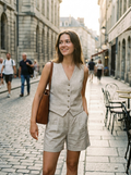 Woman wearing a textured button vest and shorts set