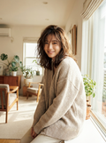 Woman wearing an oversized herringbone knit cardigan