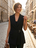 Woman wearing a notch-lapel buckle-detail blazer vest
