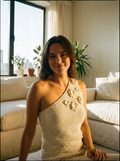 Woman wearing a one-shoulder 3D floral crochet top