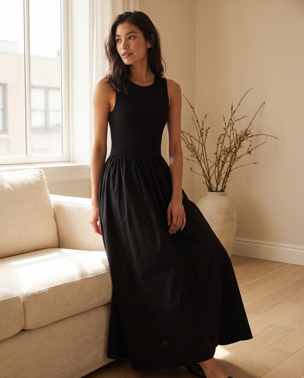 Model wearing the sleeveless jersey maxi dress, lifestyle shot