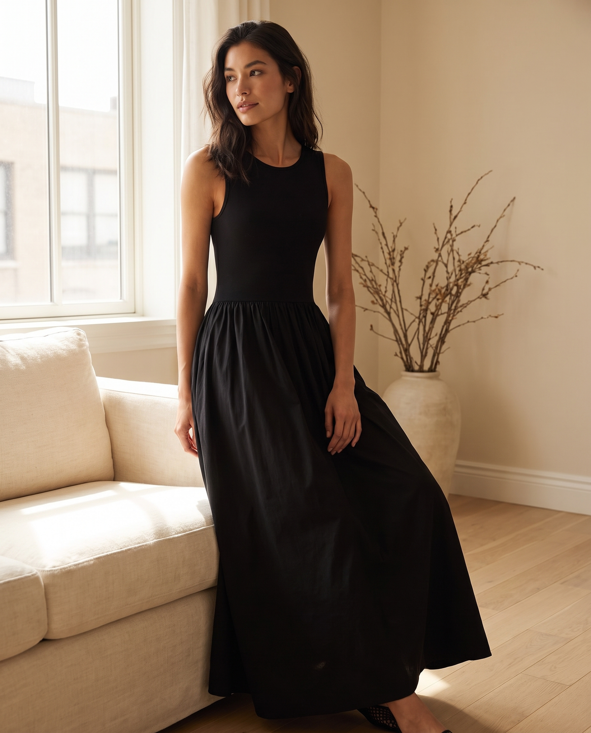 Model wearing the sleeveless jersey maxi dress, lifestyle shot