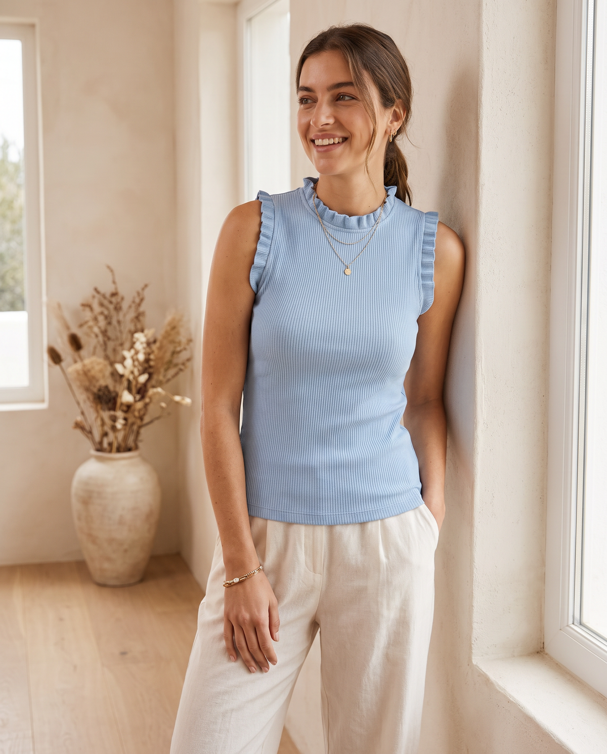 Model wearing ribbed high-neck ruffle top, lifestyle