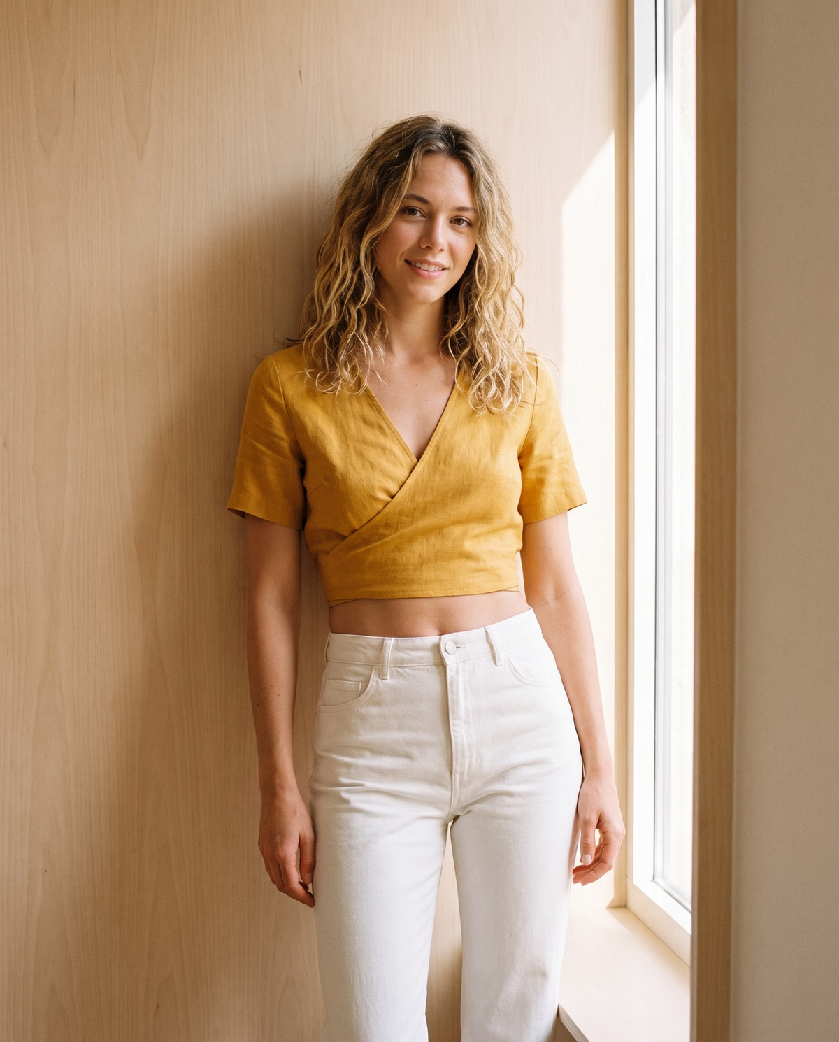 Model wearing tie-back wrap cropped short-sleeve blouse, lifestyle
