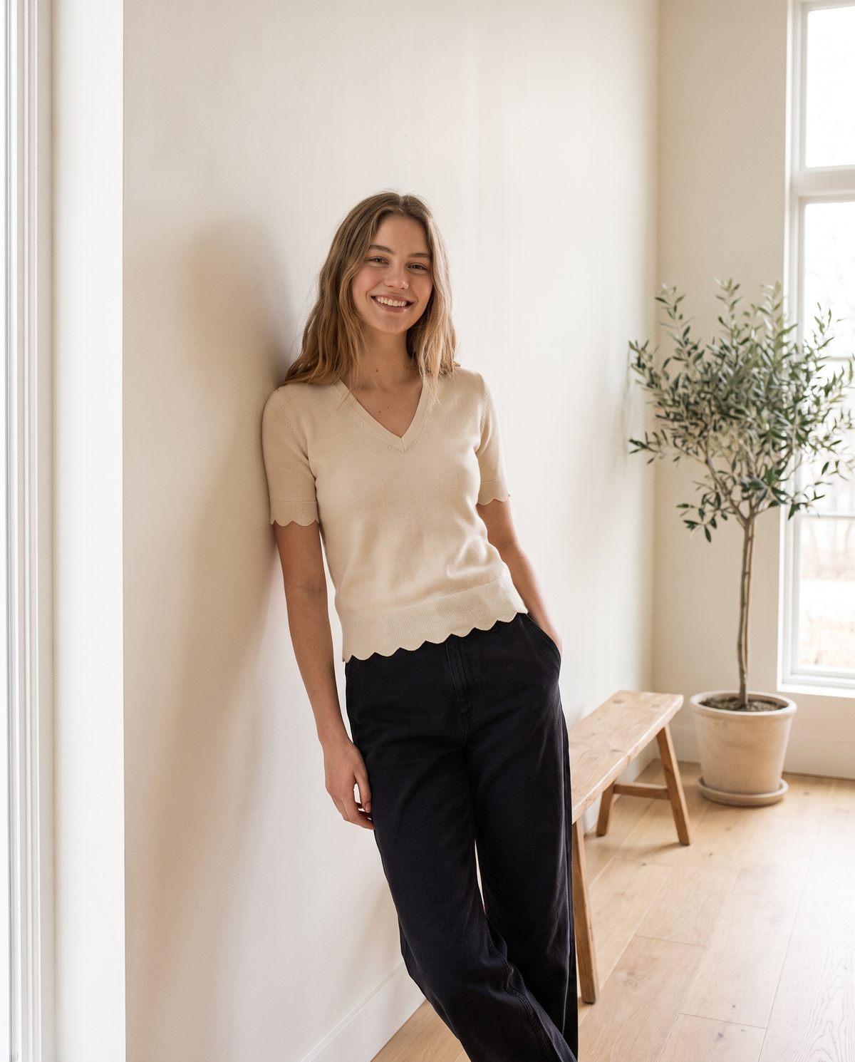 Model wearing V-neck scalloped-hem knit top, lifestyle
