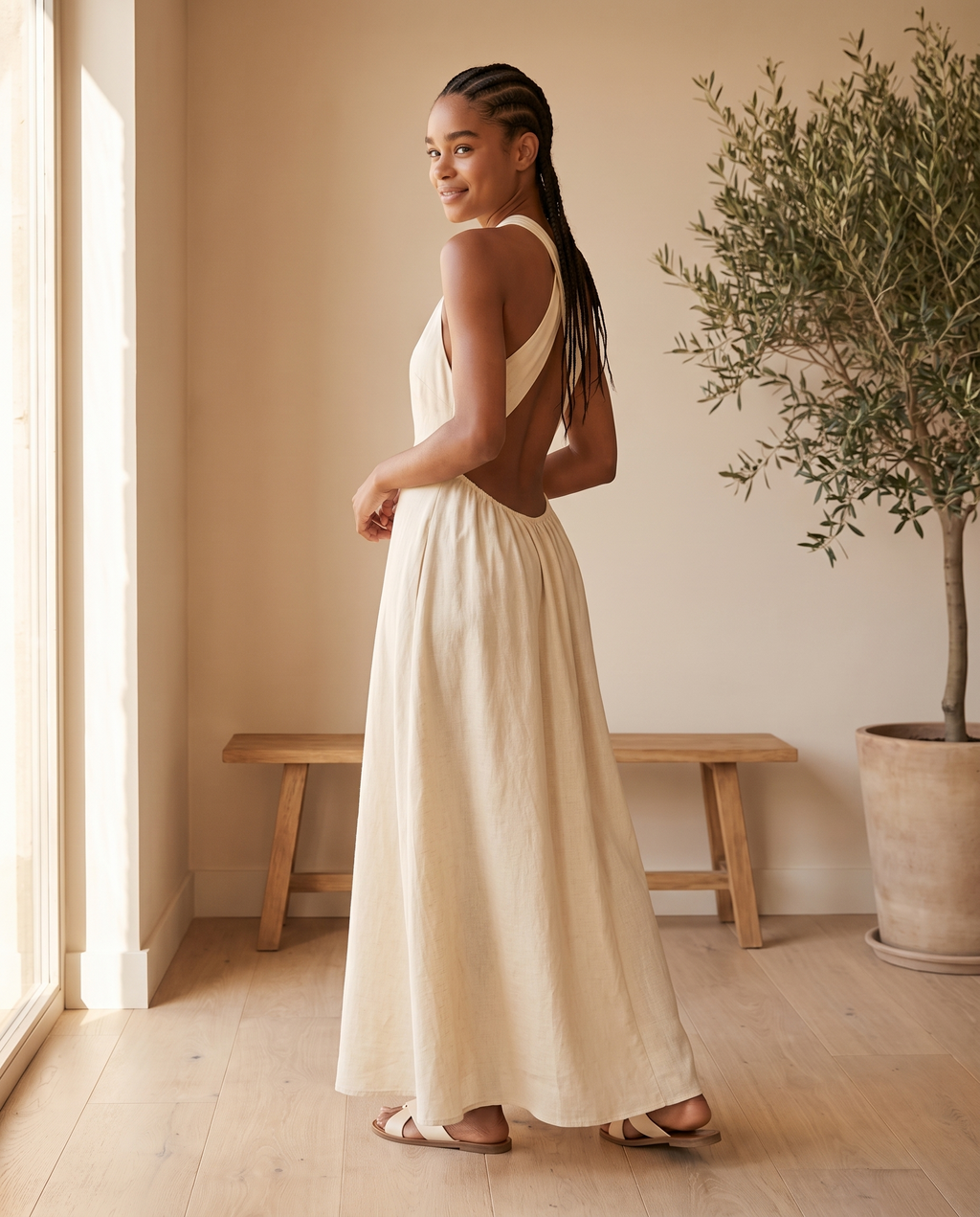 Model wearing open-back sleeveless maxi dress, lifestyle