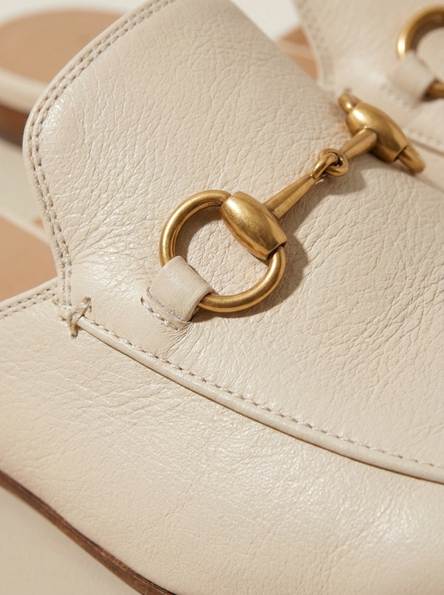 Close-up of the gold horsebit hardware and leather stitching