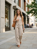 Woman wearing a pinstriped linen vest and pants set, front