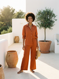 Woman wearing an orange cotton linen top and wide-leg pants set, front