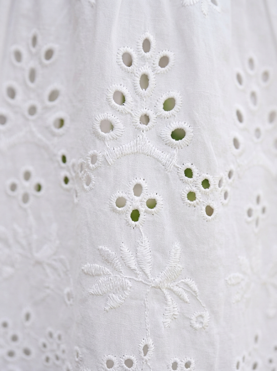 Embroidered eyelet broderie anglaise fabric detail