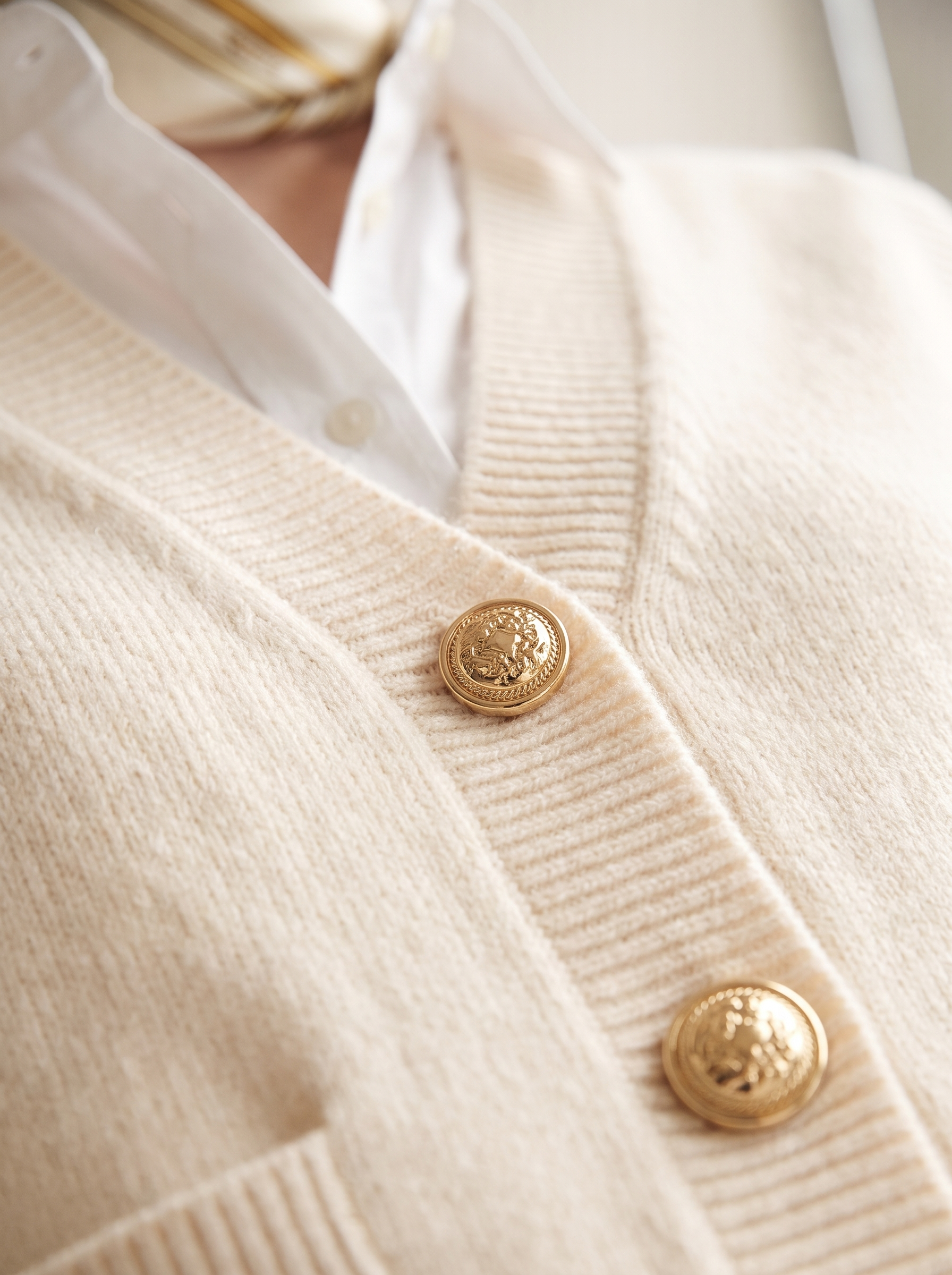 Golden buttons and knit texture detail