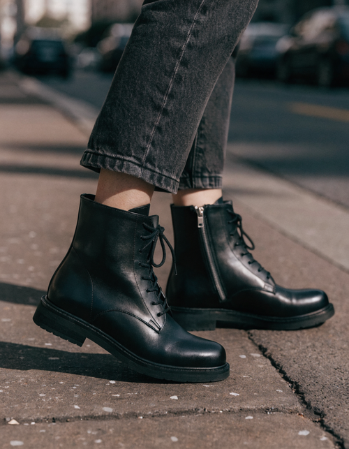 Black lace-up ankle boots with side zip and stacked sole worn with straight-leg jeans