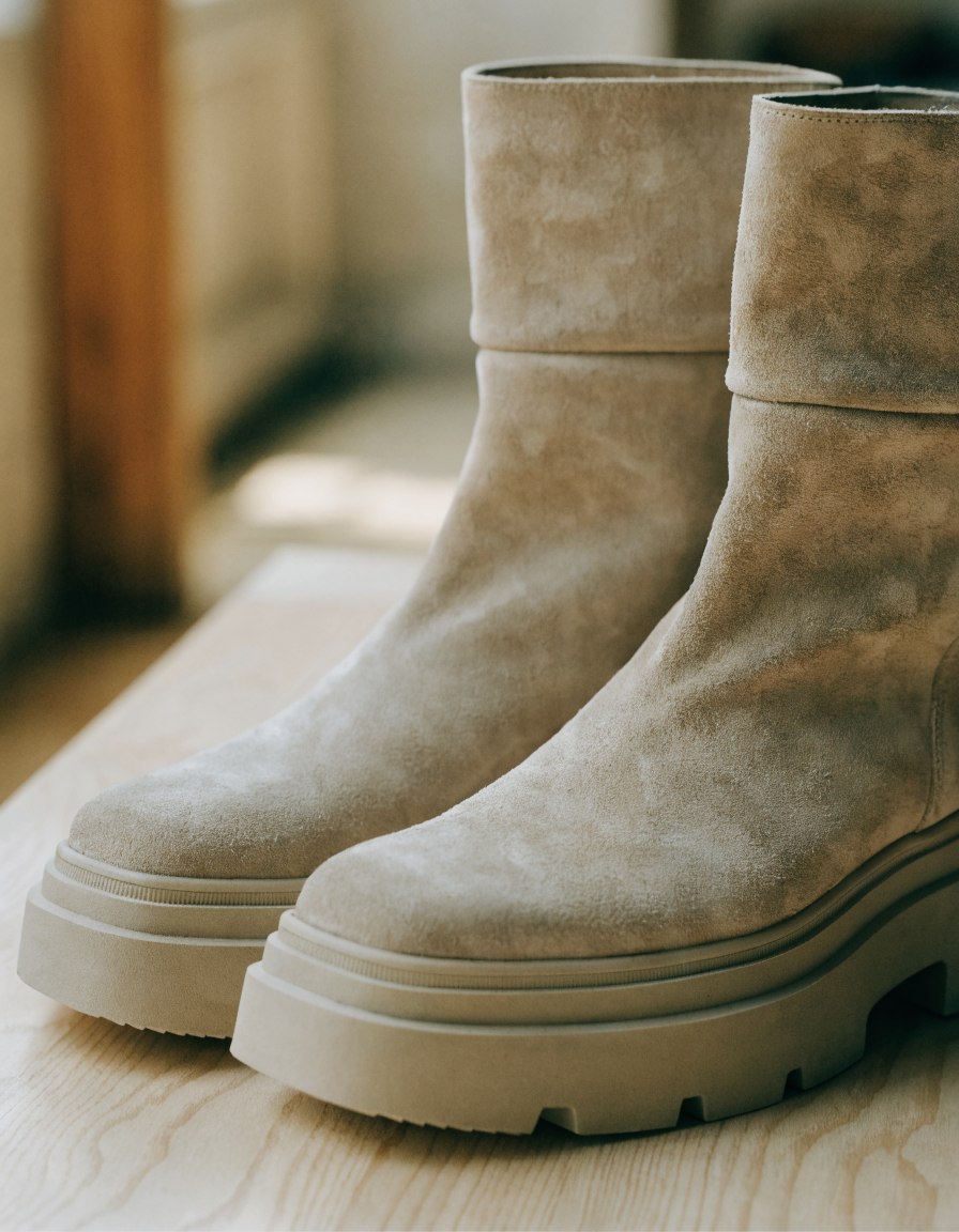 Beige fold-over cuff ankle boots with the cuff pulled up, showing the taller shaft