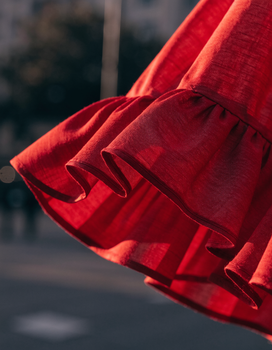 Detail of the red ruffle hem caught mid-movement