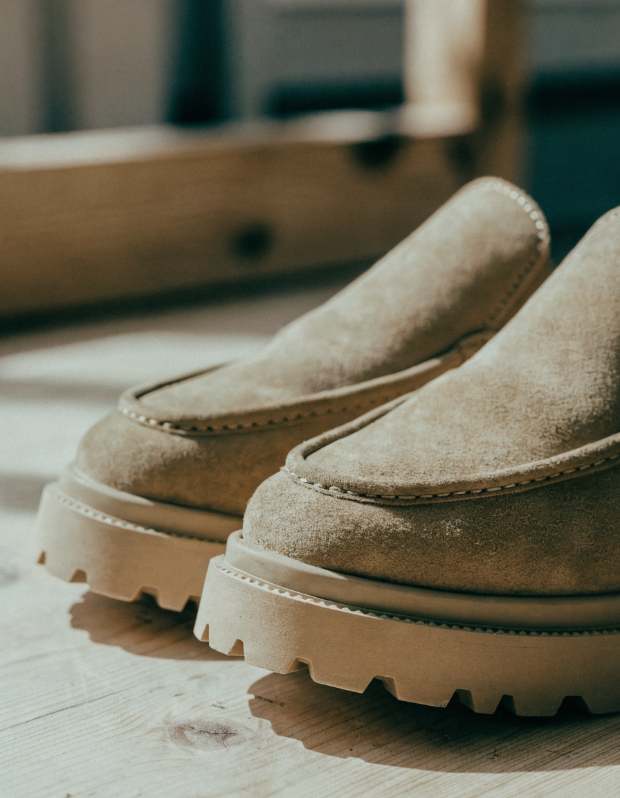 Khaki faux suede loafers with a moc toe stitch and chunky lug sole