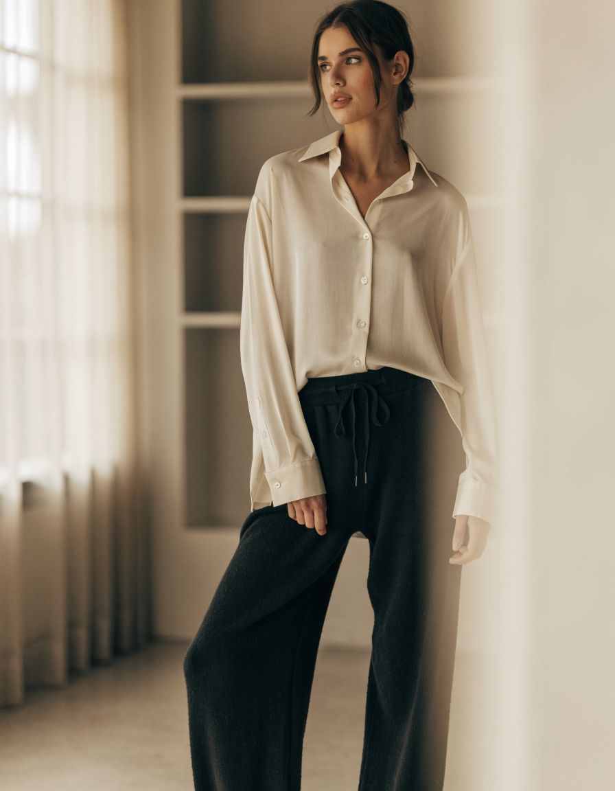 Black wide leg lounge knit pants styled with an oversized cream shirt