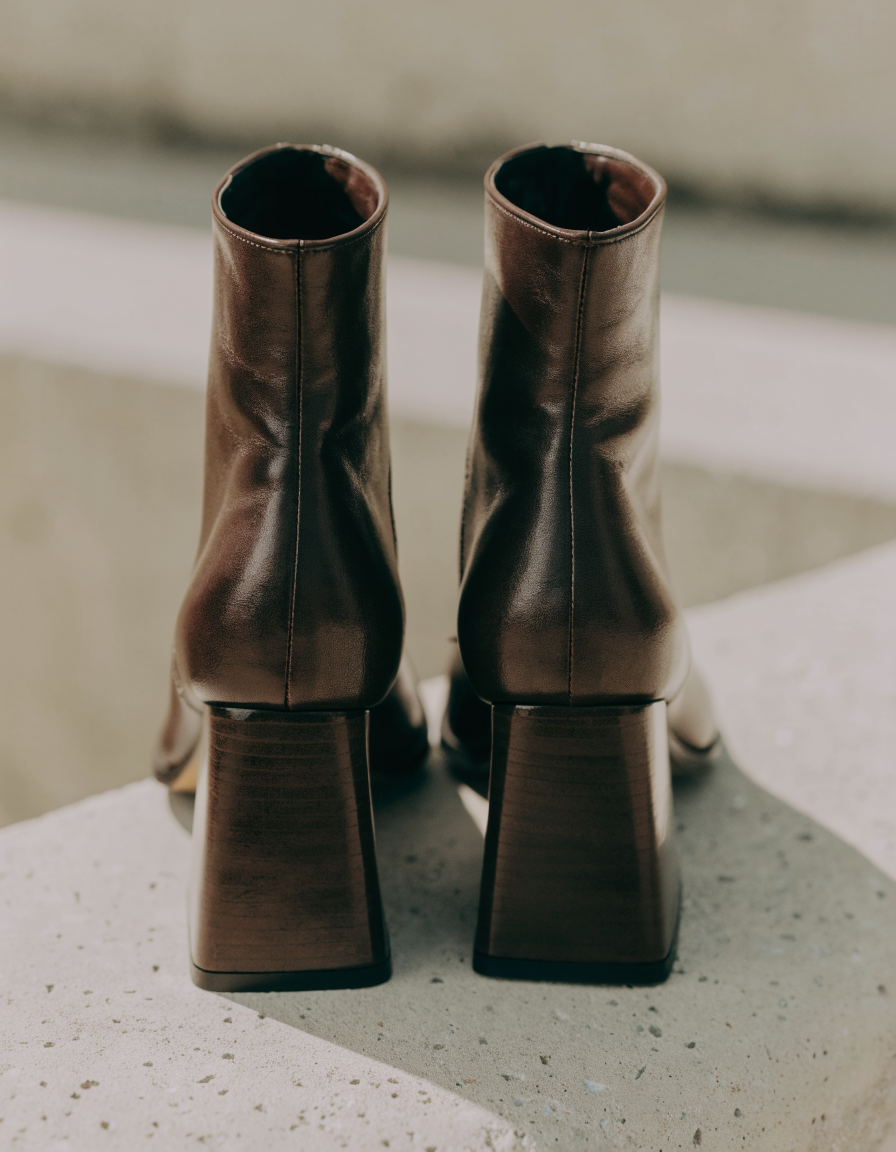 Rear view of the dark brown ankle boots showing the block heel profile